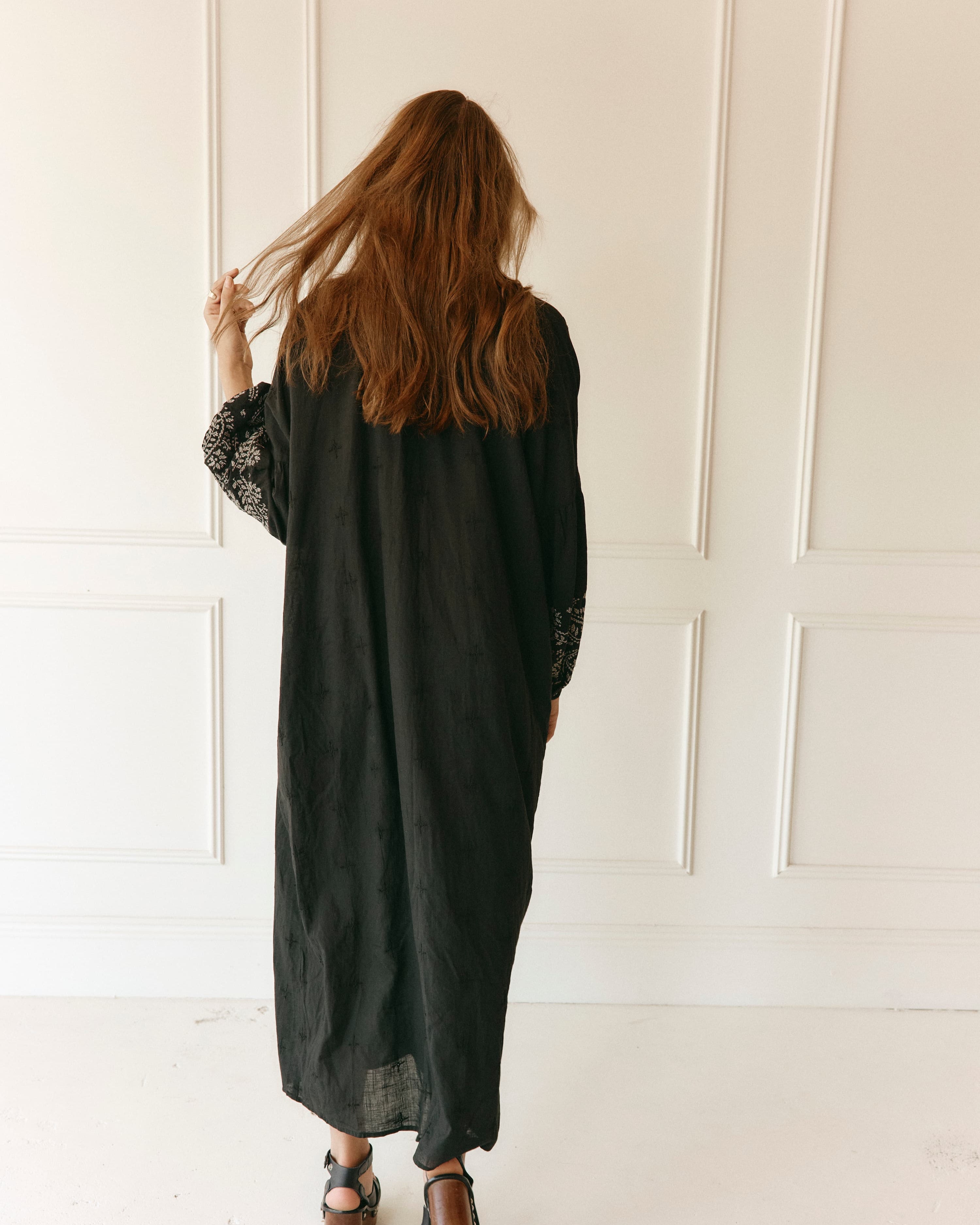 Lakoen Celeste caftan style Dress in black cotton with off white paisley embroidery and full bishop sleeves