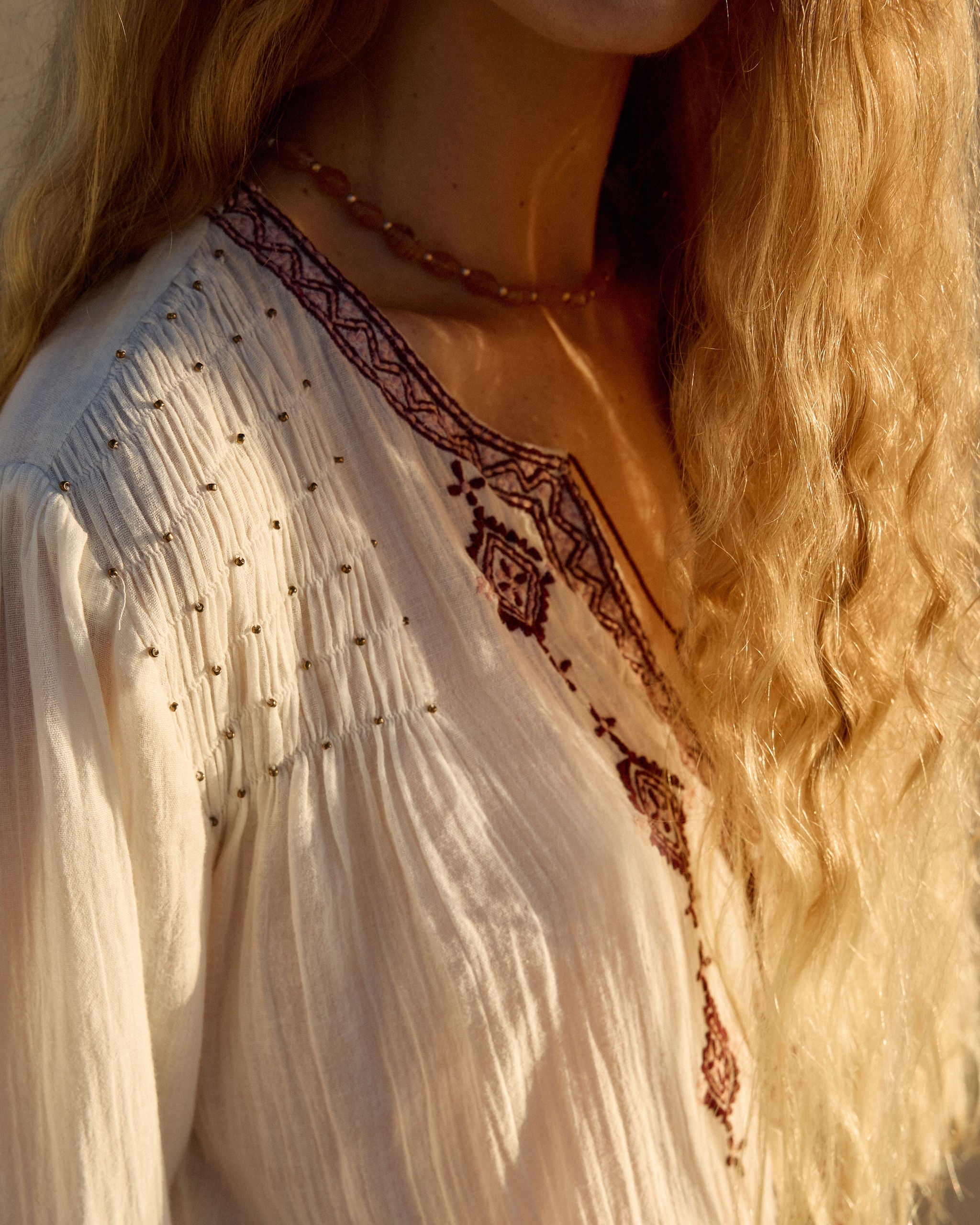 Lakoen Somi Blouse in white cotton with burgundy embroidery and hand-beaded shirring detail