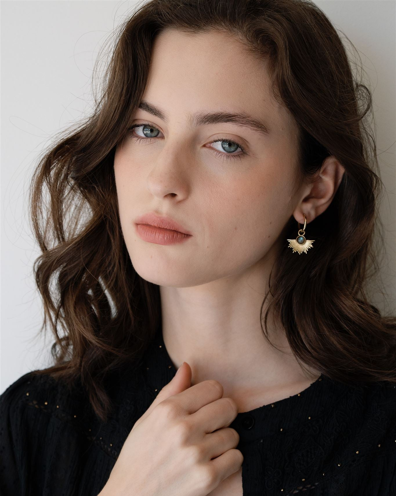 Lakoen Celeste earrings in polished brass with faceted labradorite and a halo of brass strands. Clear plated