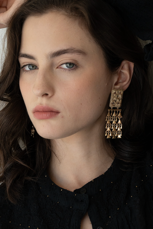 LAKOÈN model wearing our hand hammered brass Indira Drop Earrings set with faceted garnets and strung with delicate triangles - jewellery - hand-crafted -bohemian - slow luxury - handmade
