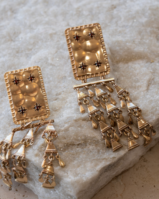 Lakoen Indira Drop earrings in recycled brass with clear plating. Set with red garnets.