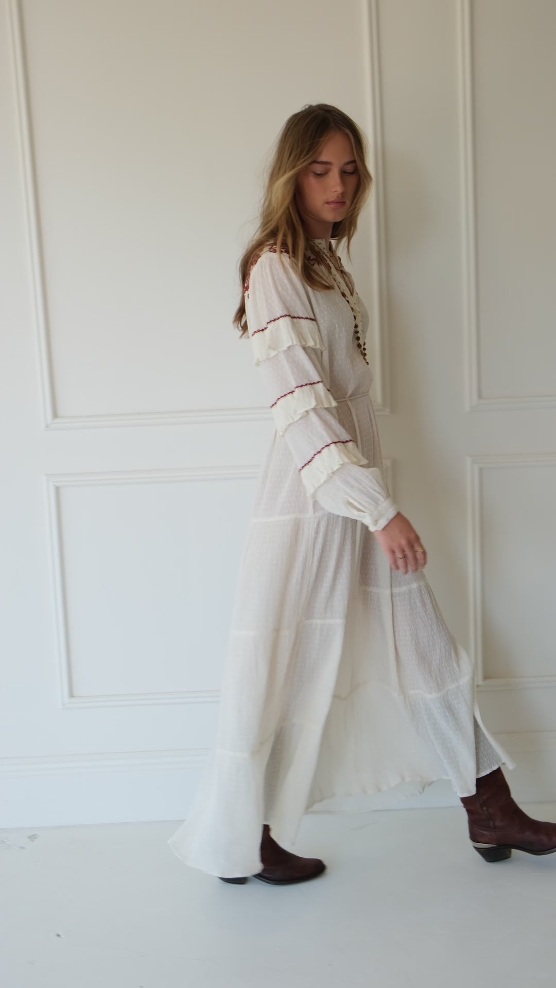 Lakoen Anais Dress in white cotton dobby with floral embroidery in burgundy and frilled bishop sleeves