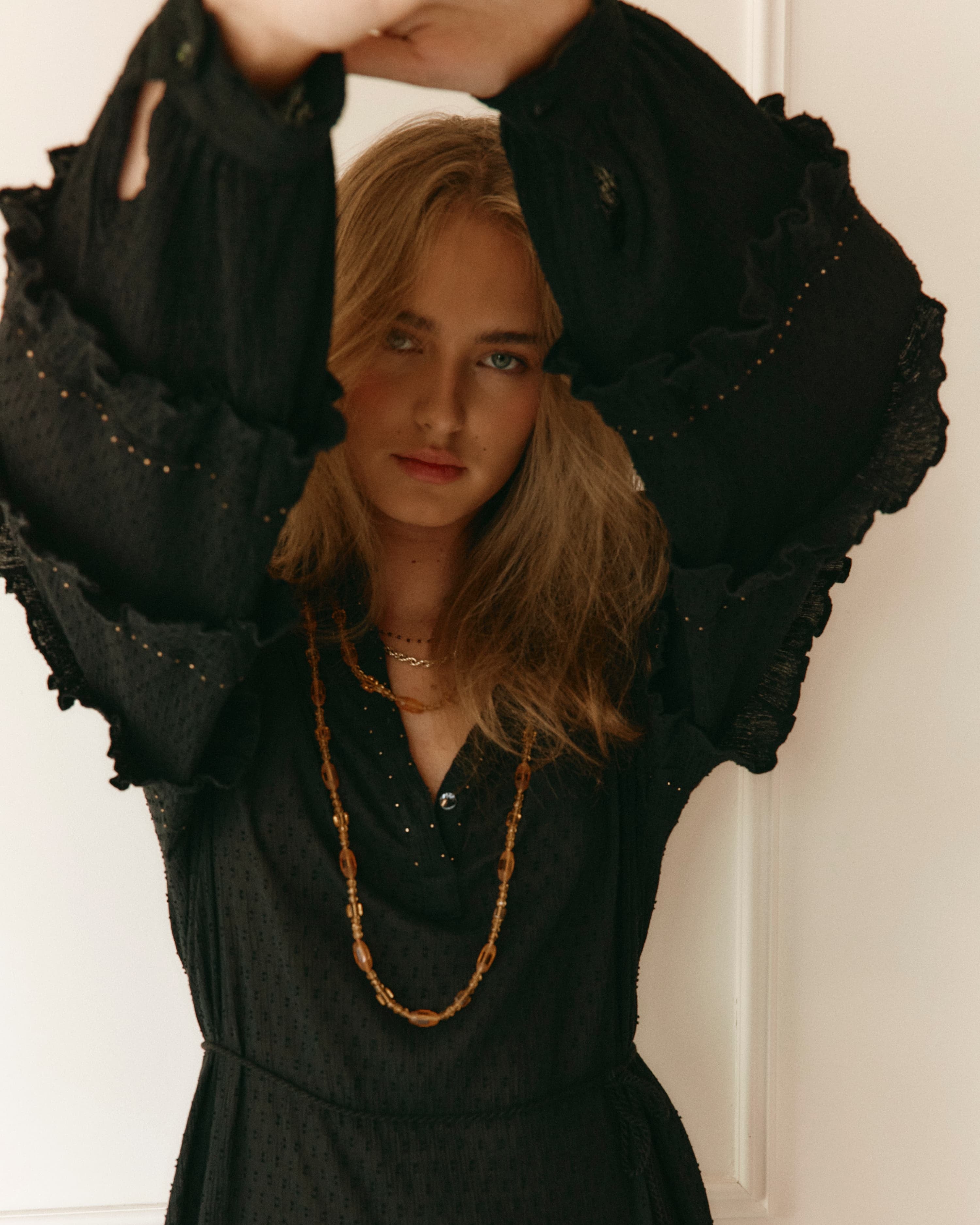 Lakoen Anais Dress in black cotton with gold beading flounced sleeves and floral embroidery
