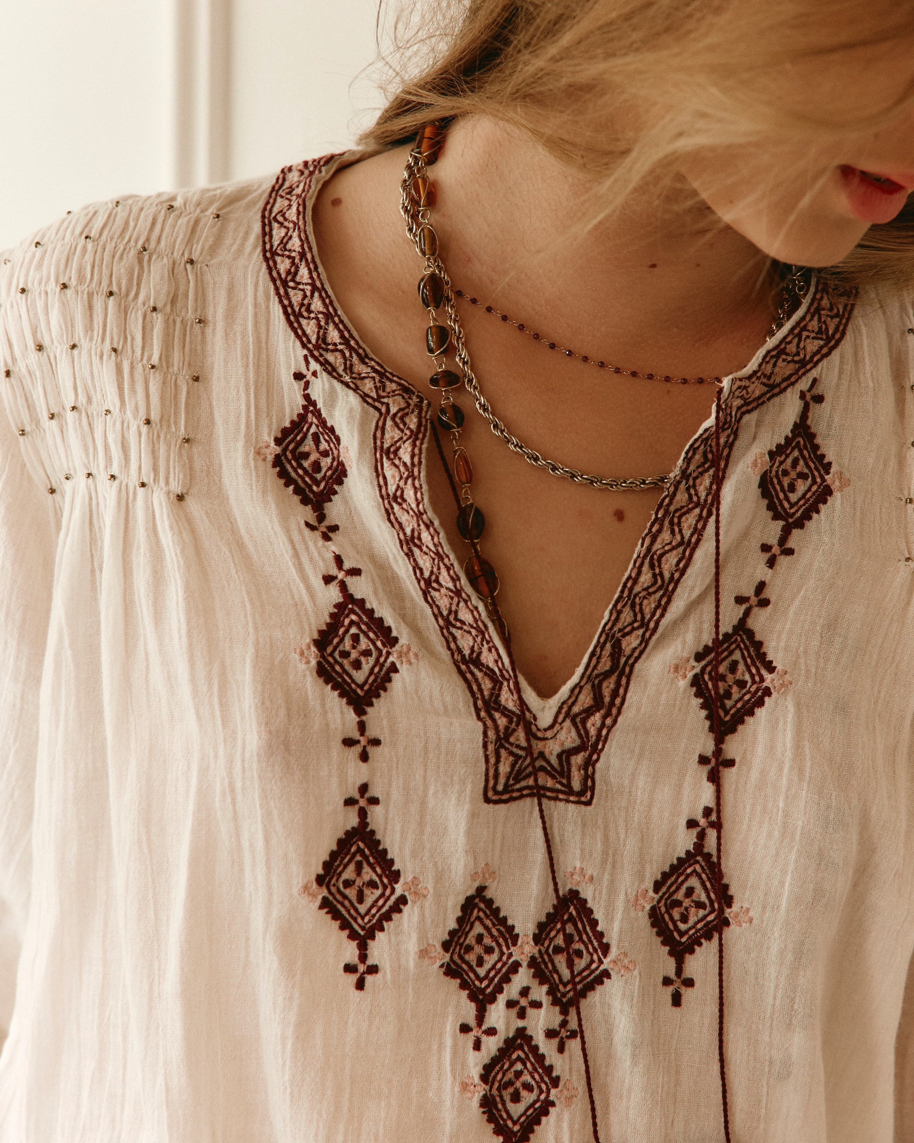 Lakoen Somi Blouse in white cotton with burgundy embroidery and hand-beaded shirring detail