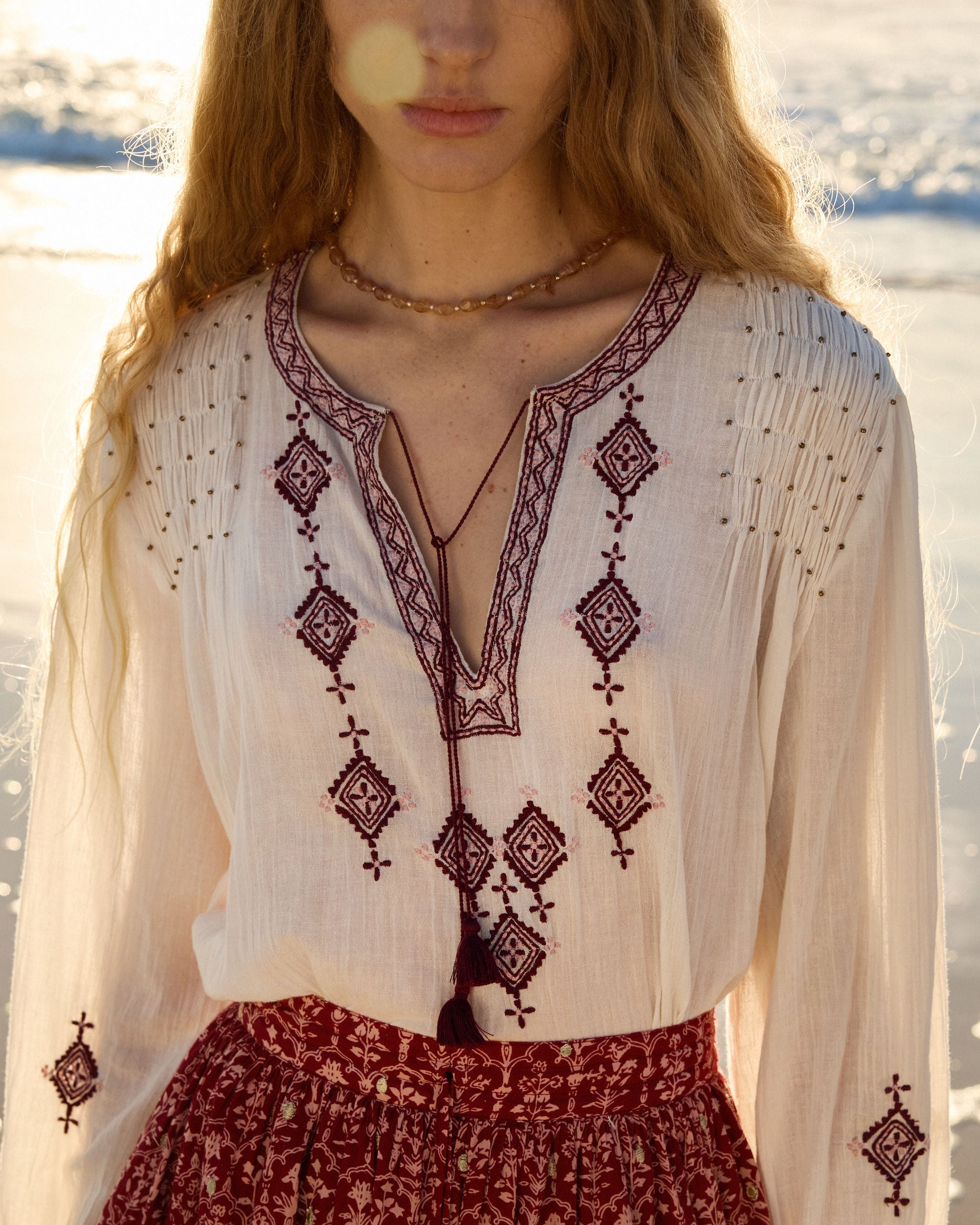 Lakoen Somi Blouse in white cotton with burgundy embroidery and hand-beaded shirring detail