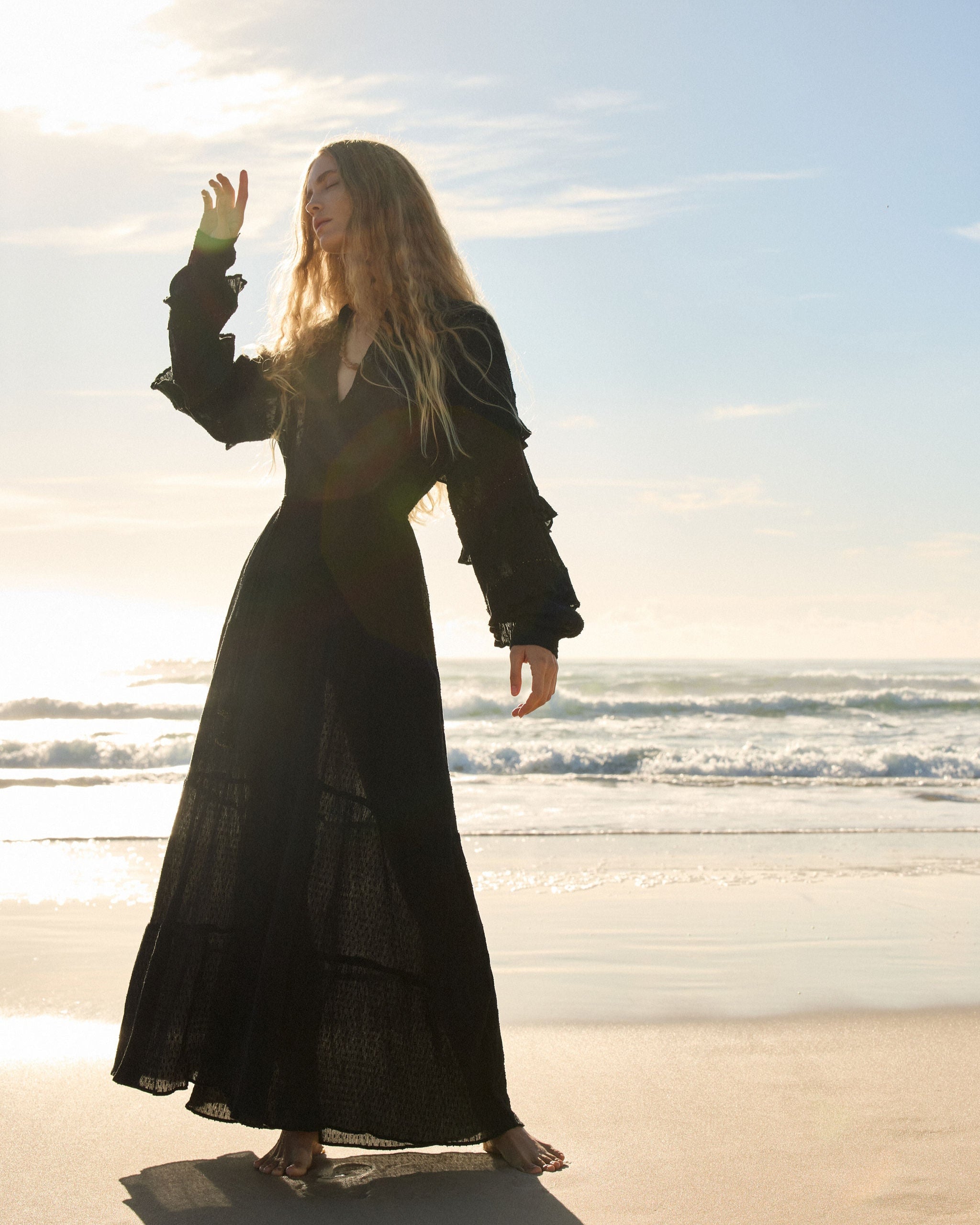 Lakoen Anais Dress in black cotton with gold beading flounced sleeves and floral embroidery